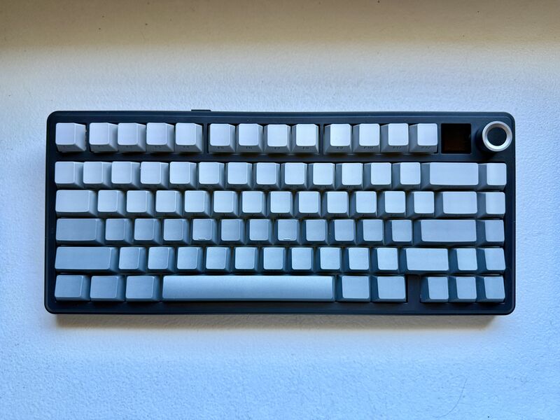 A keyboard with gradient gray keys, it's a top view shot but there's no legends on the keycaps.